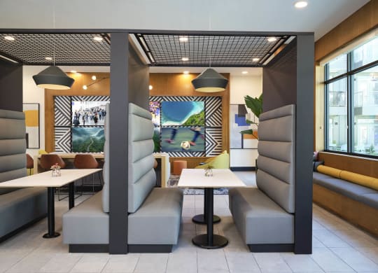 a restaurant with tables and chairs and a mural on the wall