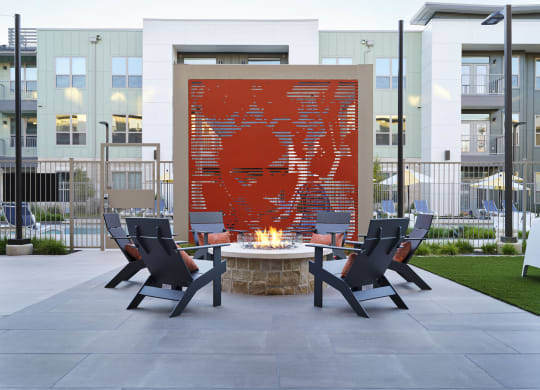 an outdoor patio with chairs and a fire pit