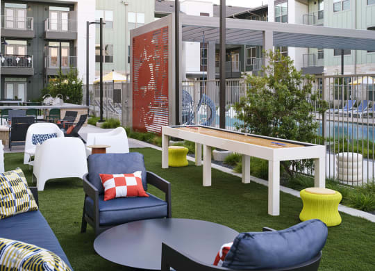 a communal area with chairs and tables and a pool