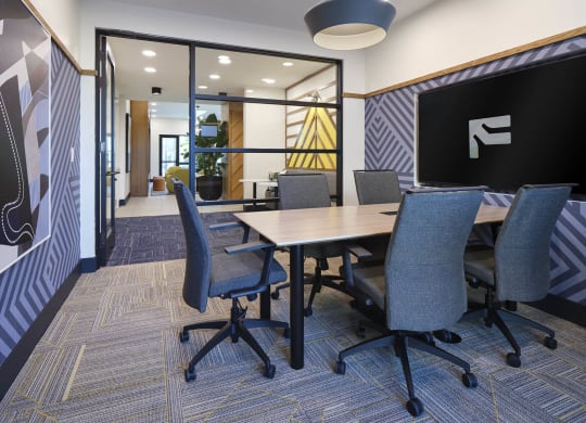 a conference room with a table and chairs