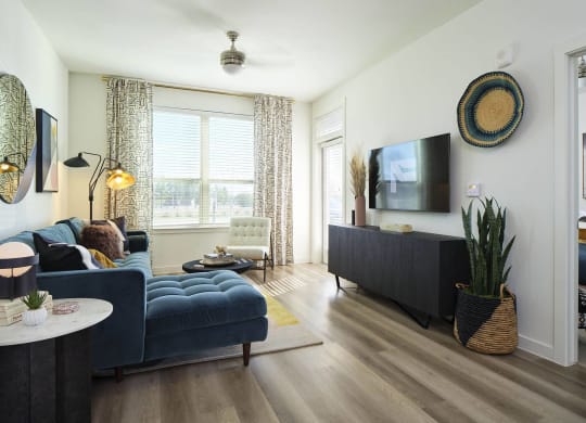 a living room with a blue couch and a tv