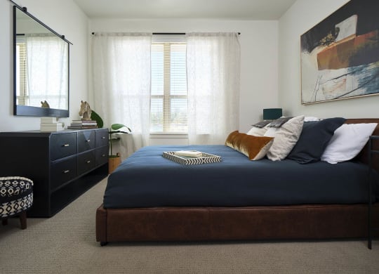 a bedroom with a large bed and a dresser