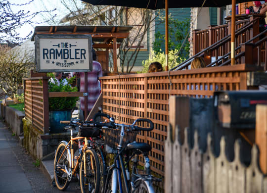 a row of bikes parked in front of a brick fence