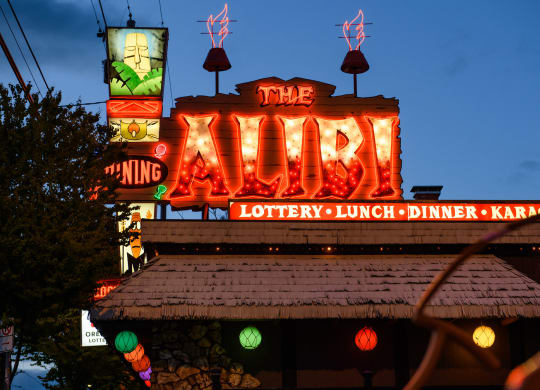 the war theater lit up at night at the war neon sign