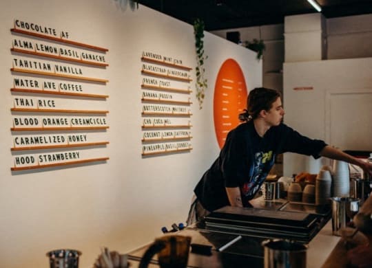 a woman is working at a counter at a restaurant