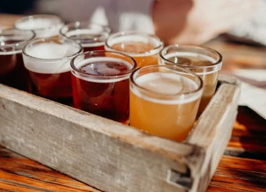 a wooden box filled with different types of beers
