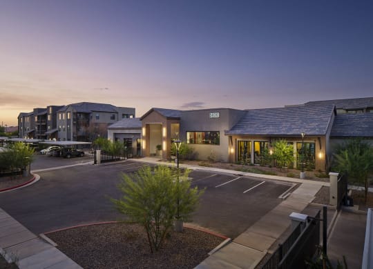 the building where the hotel is located is lit up at dusk
