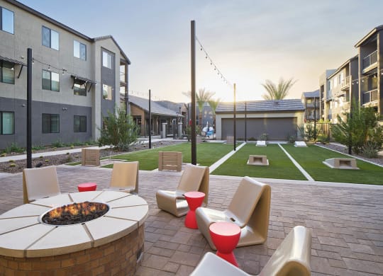 an outdoor patio with chairs and a fire pit