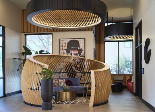 the lobby or reception area of a hotel with a wooden reception desk