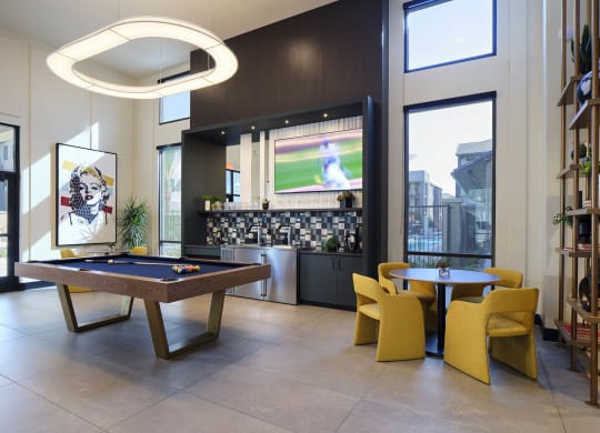 a game room with a pool table and a television