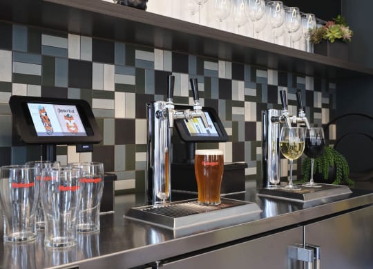 a bar with pitchers of beer and glasses on it