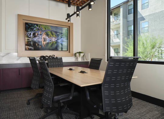 a conference room with a wooden table and chairs