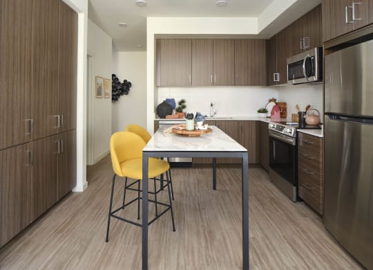 a kitchen with a table and chairs