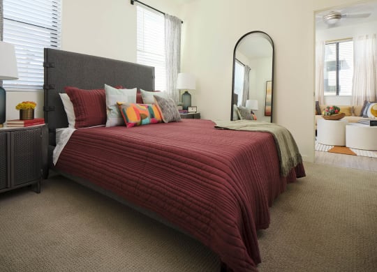 a bedroom with a bed and a mirror