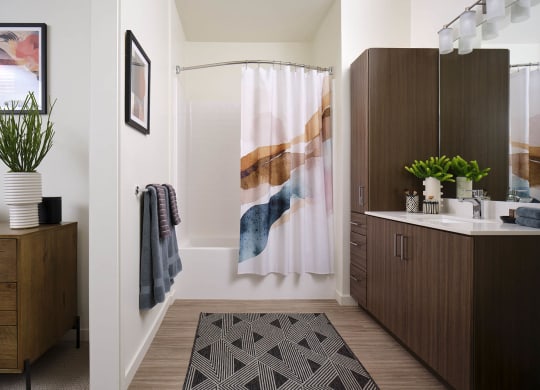 a bathroom with a shower and a sink in it