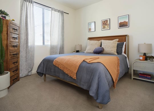 a bedroom with a bed and a dresser