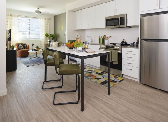 a kitchen and dining room with a table and chairs
