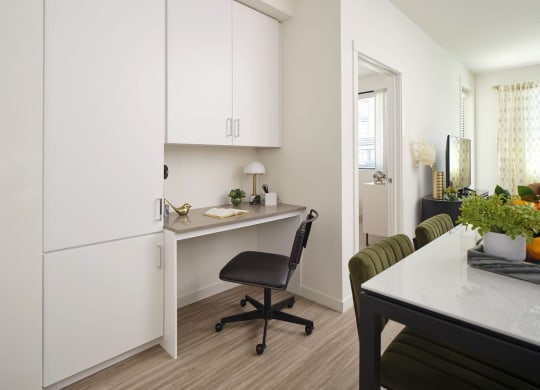a kitchen or kitchenette with a desk and a chair