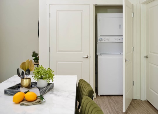 a kitchen and dining room with white appliances and a table