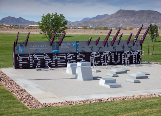 a sculpture of baseball bats on display in a park