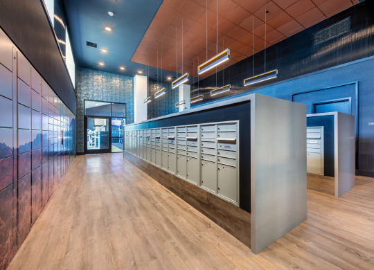 the lobby of a building with a long row of mailboxes
