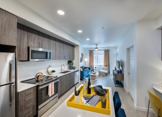 a kitchen and living room with a yellow table