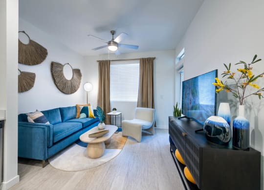 a living room with a blue couch and a tv