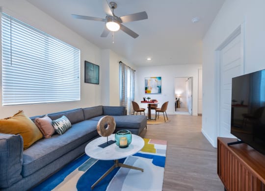 a living room with a couch and a ceiling fan