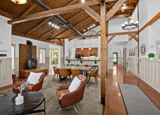 a living room with chairs and a table and a kitchen
