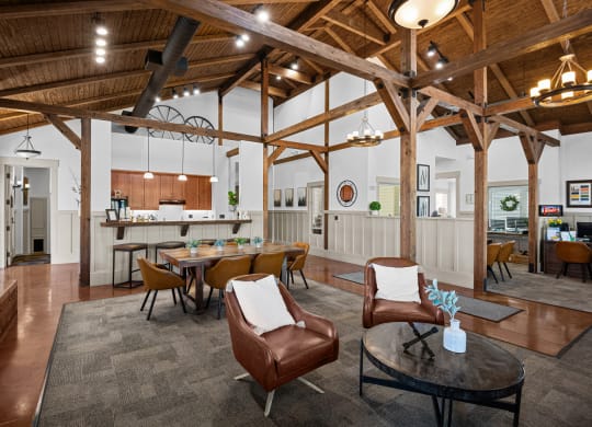 a living room with a table and chairs and a kitchen