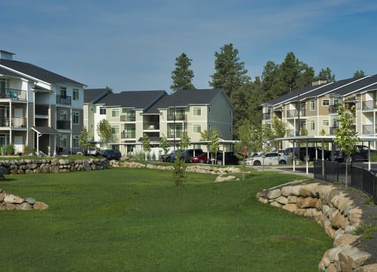 River House Apartments Spacious Grass Fields and Exterior Buildings