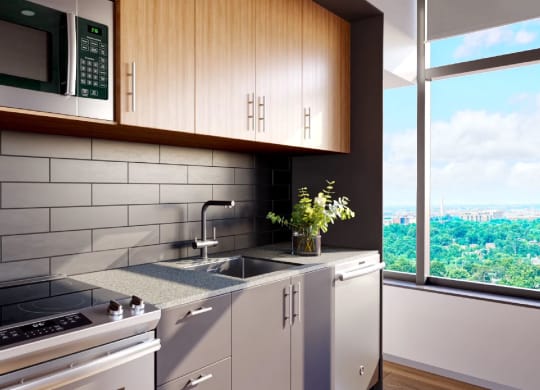 a kitchen with a stove and a sink next to a window