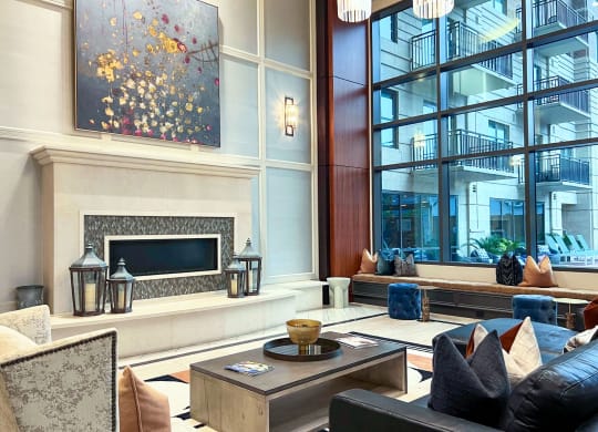 a living room with a fireplace and large windows