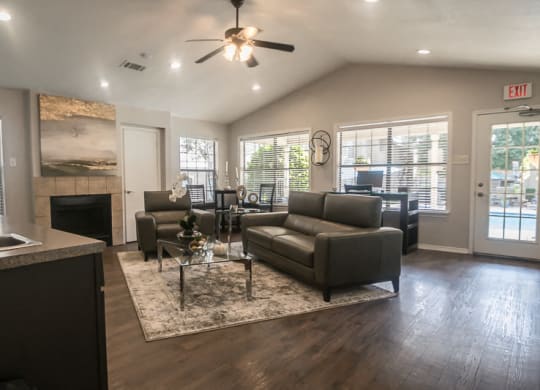 a living room with couches and a coffee table in front of a fireplace