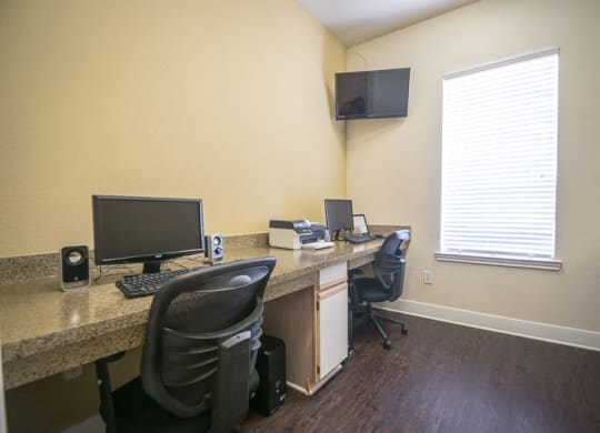 an office with a desk with a computer and a monitor at Fountains of Denton in Denton, TX