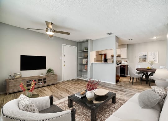 our apartments offer a living room with a couch a coffee table and a flat screen tv