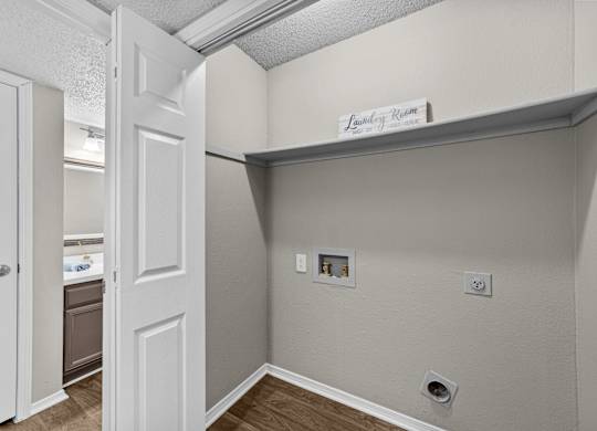 Laundry room with a door and a sign above it.