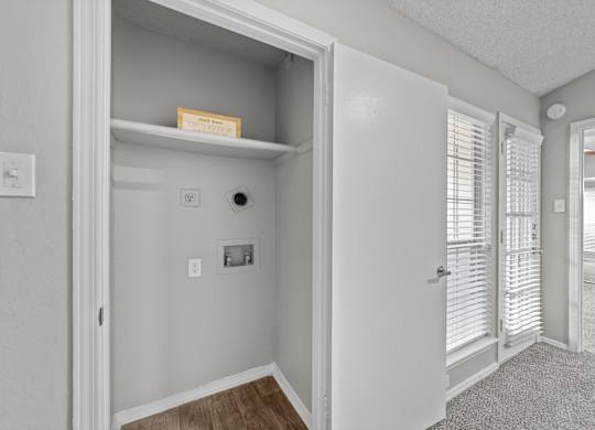 A white door is open to a hallway.