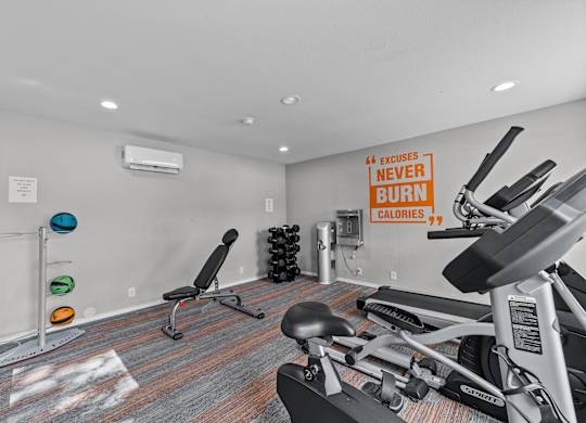 A gym room with a row of exercise bikes and a sign that says