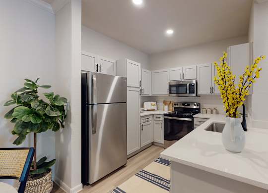 a kitchen with white cabinetry and stainless steel appliances  at Remington Ranch, San Antonio, Texas