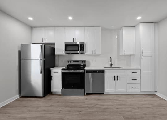 a white kitchen with stainless steel appliances and white cabinets at Sunset Heights, San Antonio, 78209