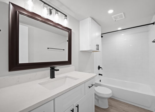 a bathroom with a sink and a toilet and a shower at Sunset Heights, Texas