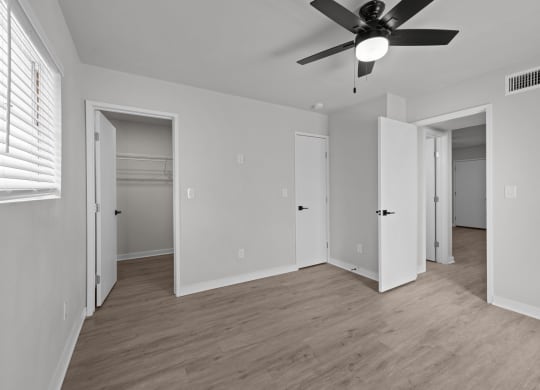 the living room of an empty house with a ceiling fan at Sunset Heights, Texas, 78209