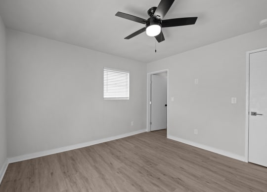 Photo of renovated bedroom with ceiling fan and vinyl flooring at Sunset Heights, San Antonio