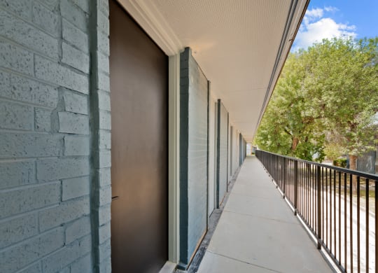 a long balcony with a metal fence on the side of a building at Sunset Heights, San Antonio