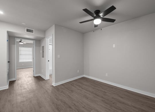 Photo of renovated bedroom with ceiling fan and vinyl flooring at Sunset Heights, San Antonio