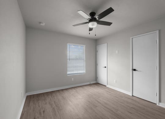 Photo of newly renovated bedroom with vinyl flooring and ceiling fan at Sunset Heights, San Antonio, 78209