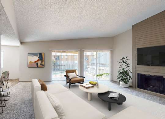 A living room with a white couch, a coffee table, and a fireplace.