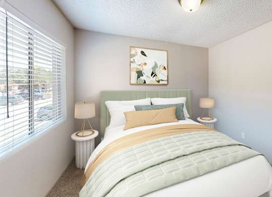 A bedroom with a large bed and a painting on the wall.