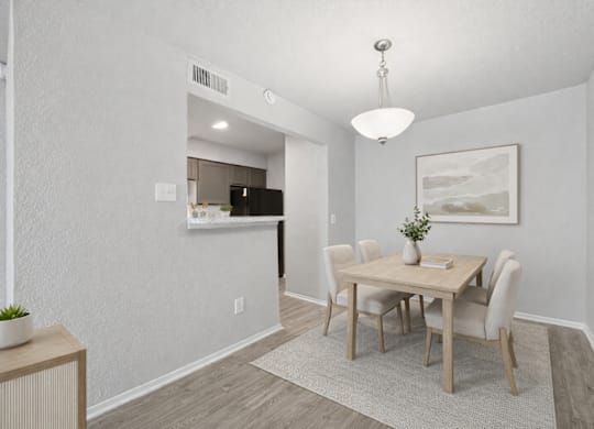 A dining room with a wooden table and chairs.
